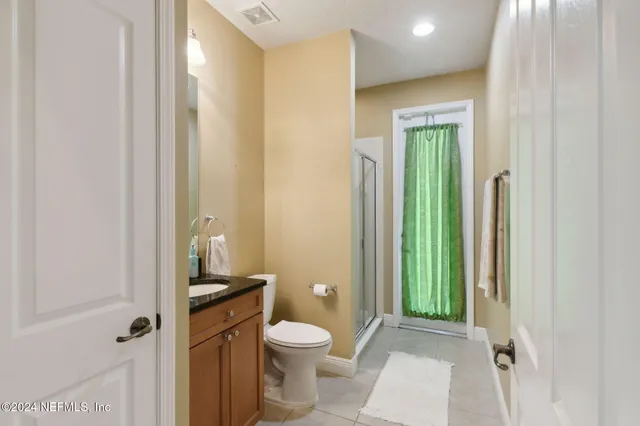 a bathroom with a toilet a sink and shower