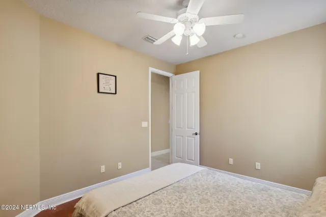 a view of a bedroom with a chandelier fan