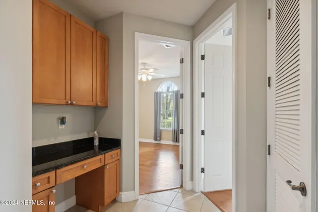 a view of a kitchen with wooden cabinets
