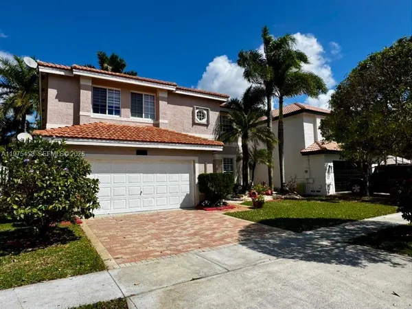 a front view of a house with a yard garage and outdoor seating