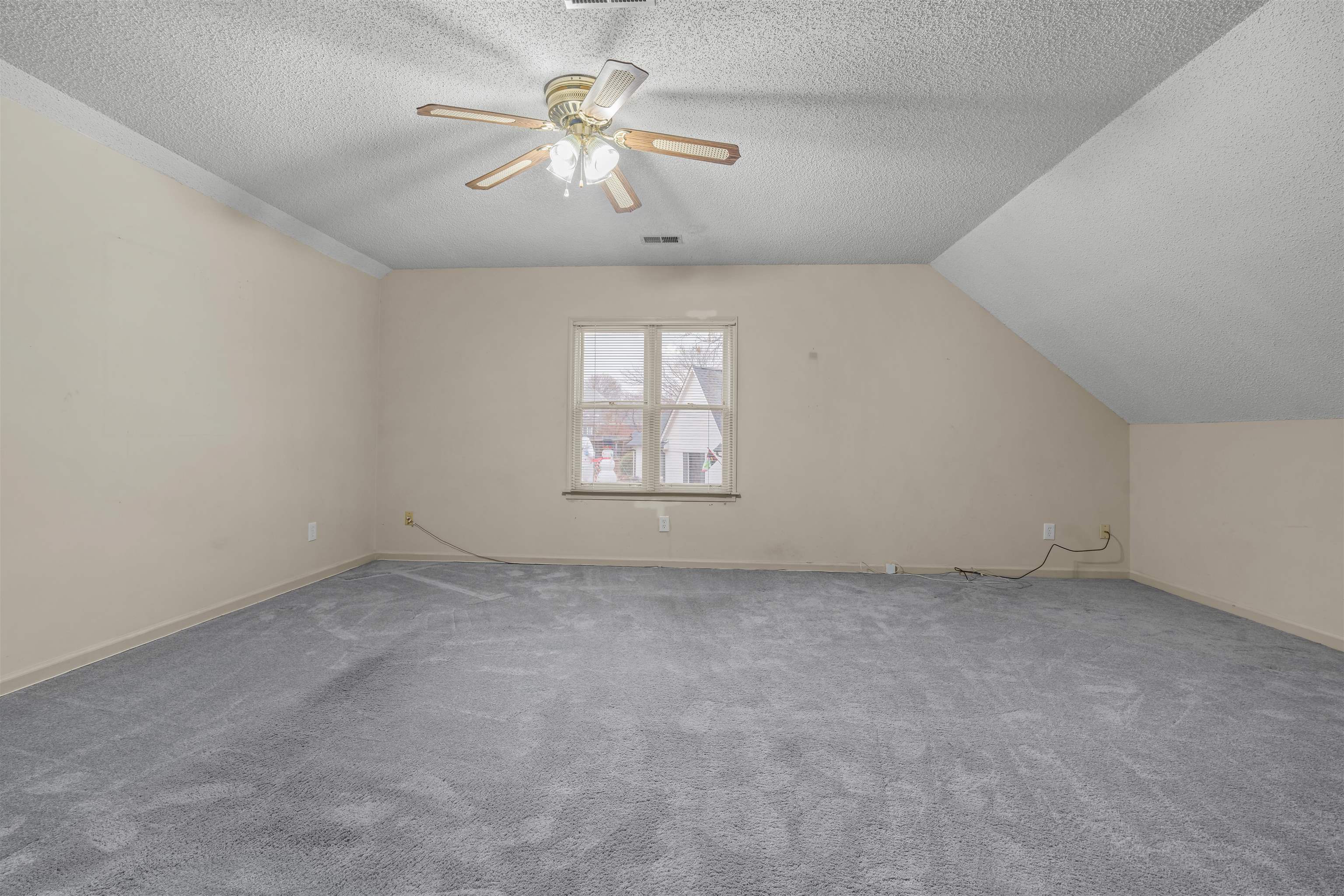9403 Shadow Ridge Cove Cordova, TN 38016 - Photo 17 of 21 an empty room with a chandelier fan and windows