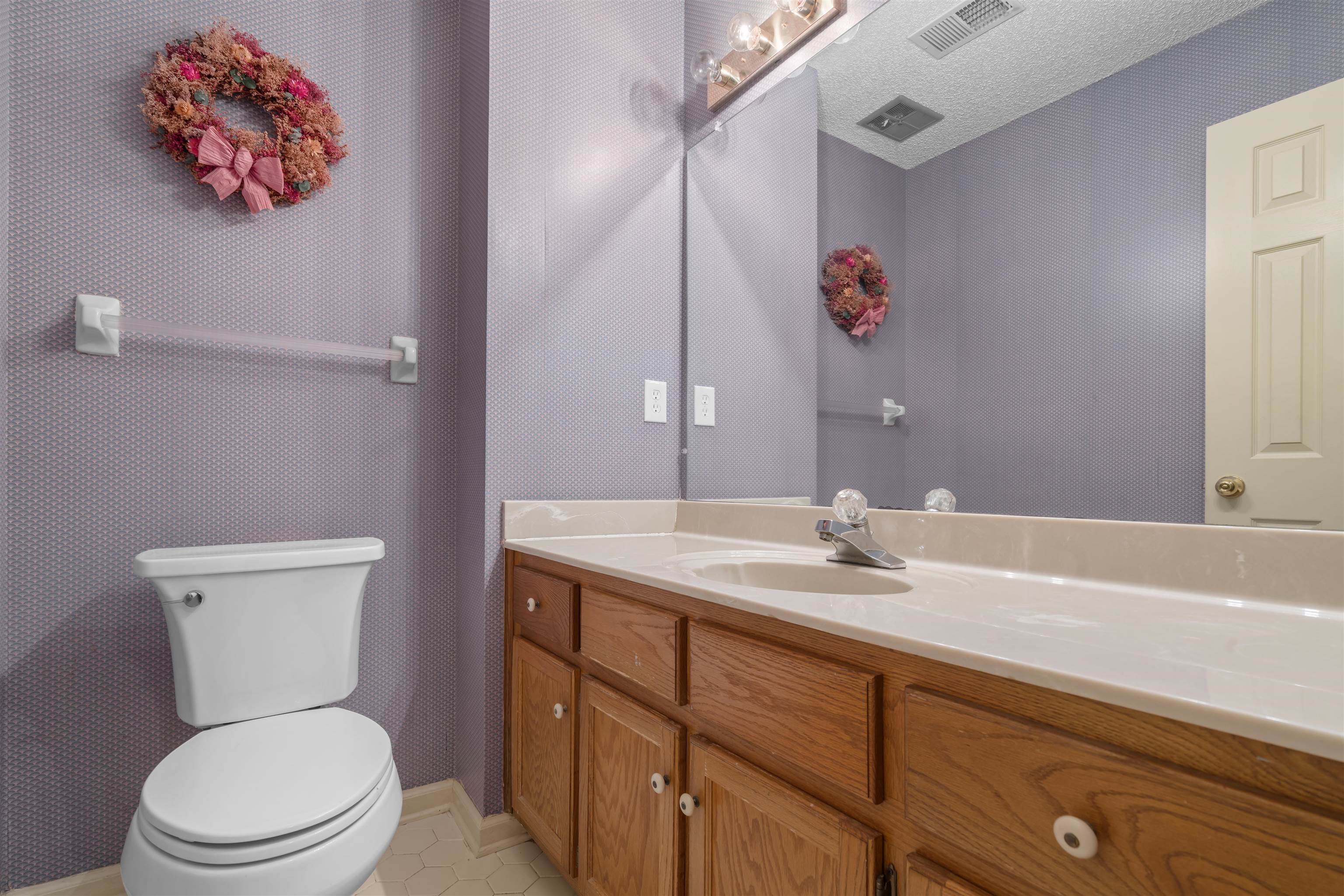 9403 Shadow Ridge Cove Cordova, TN 38016 - Photo 18 of 21 a bathroom with a toilet sink and mirror