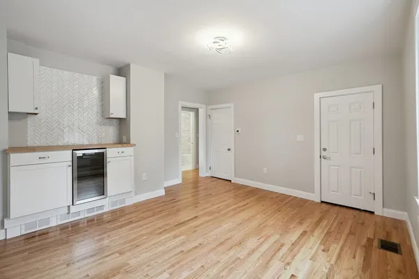 a view of kitchen with granite countertop cabinets and wooden floor