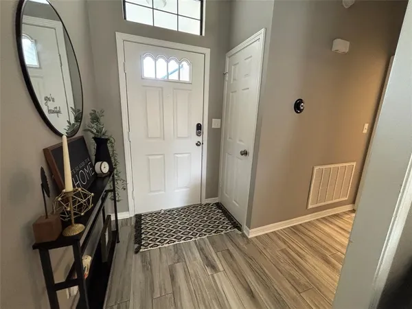 a view of a entryway door with wooden floor