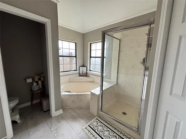 a bathroom with a bathtub and a shower