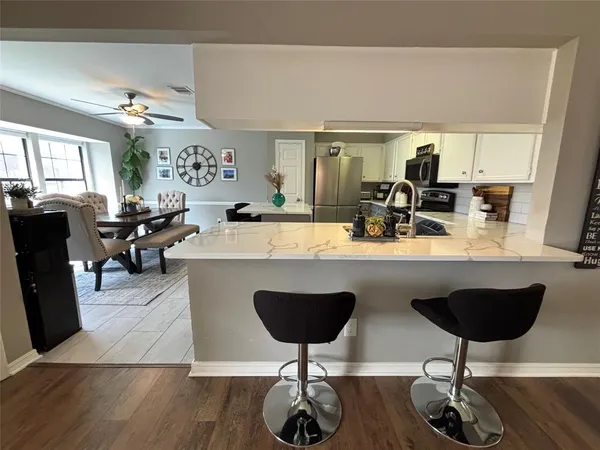 a view of living room with furniture and wooden floor