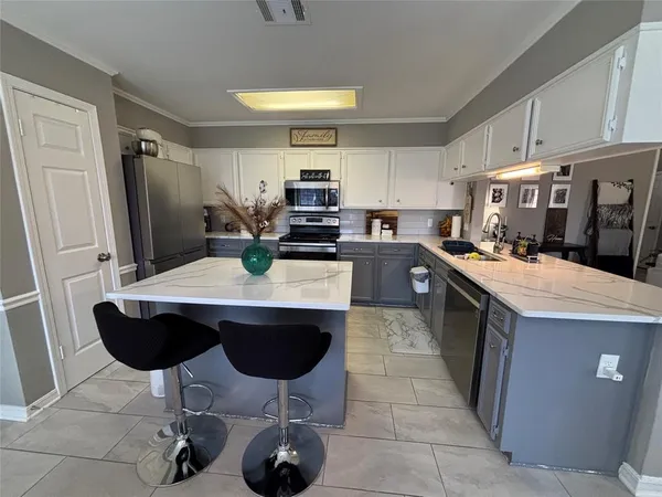 a kitchen with a table chairs stove and cabinets