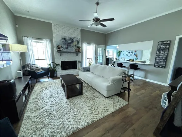 a living room with furniture large window and a fireplace
