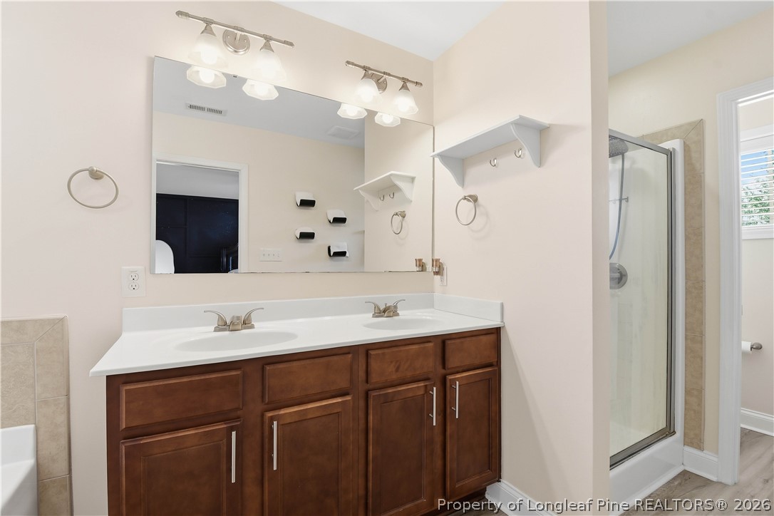 140 Birch Avenue Spring Lake, NC 28390 - Photo 46 of 49 a bathroom with a double vanity sink mirror and shower