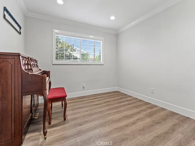 a view of a room with furniture and wooden floor