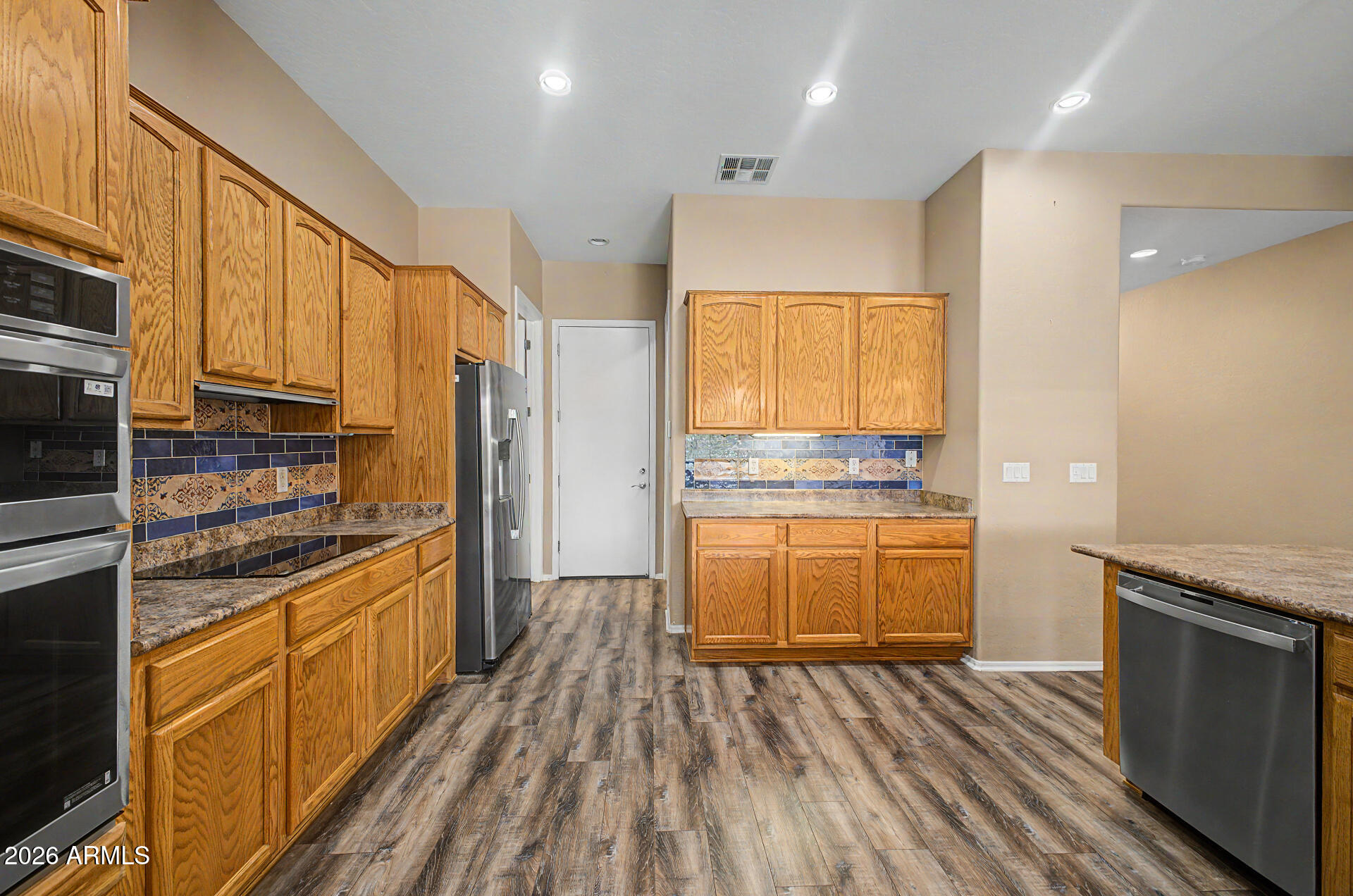 5090 South Ranger Trail Gilbert, AZ 85298 - Photo 11 of 50 a kitchen with stainless steel appliances granite countertop a stove and a refrigerator