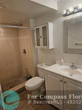 7041 Environ Boulevard, Unit 126 Lauderhill, FL 33319 - Photo 4 of 4 a bathroom with a sink a toilet and shower
