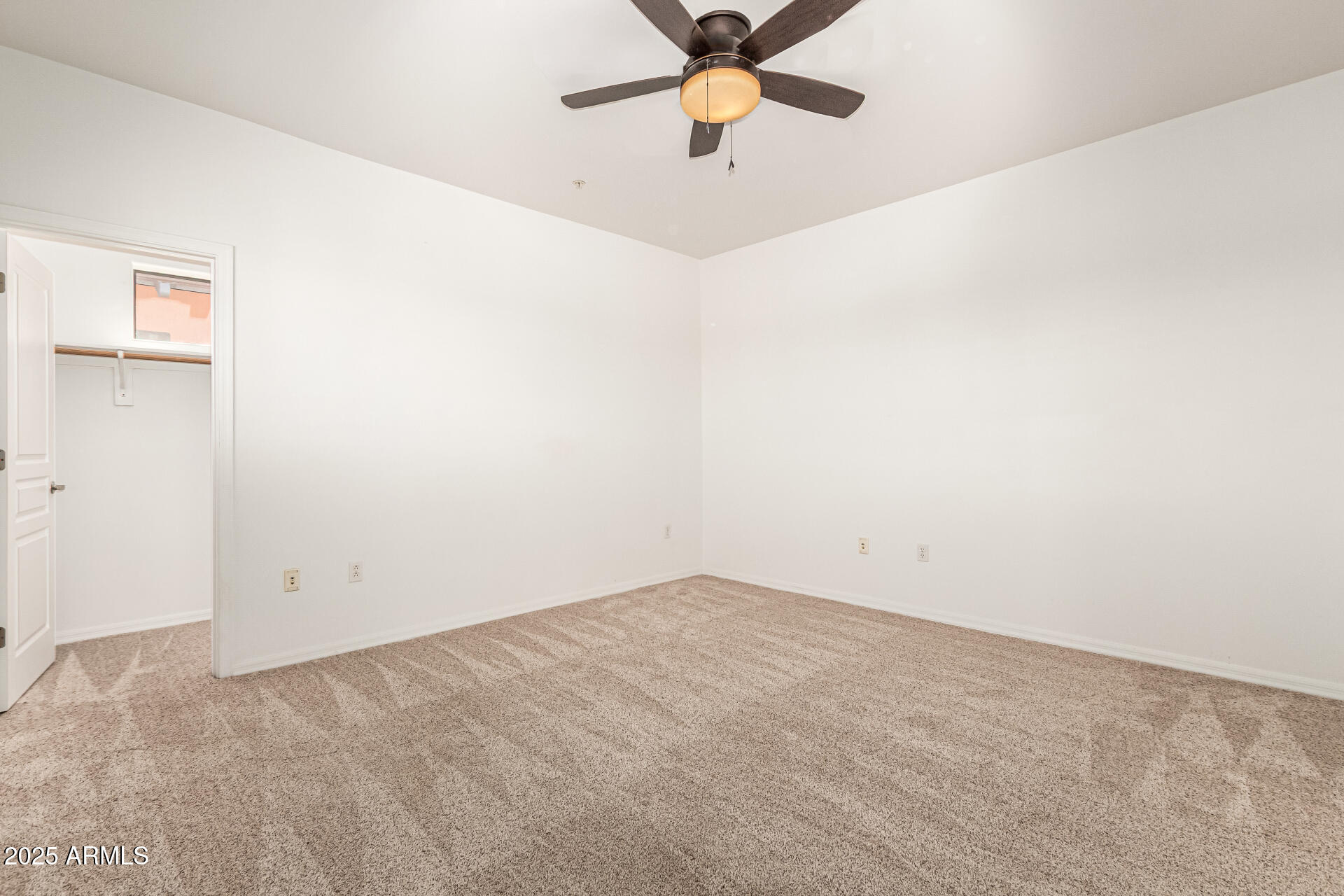 20660 North 40th Street, Unit 2120 Phoenix, AZ 85050 - Photo 13 of 39 an empty room with wooden floor and fan