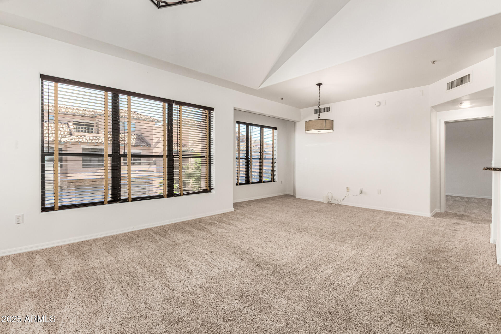 20660 North 40th Street, Unit 2120 Phoenix, AZ 85050 - Photo 3 of 39 a view of an empty room with a window and a kitchen