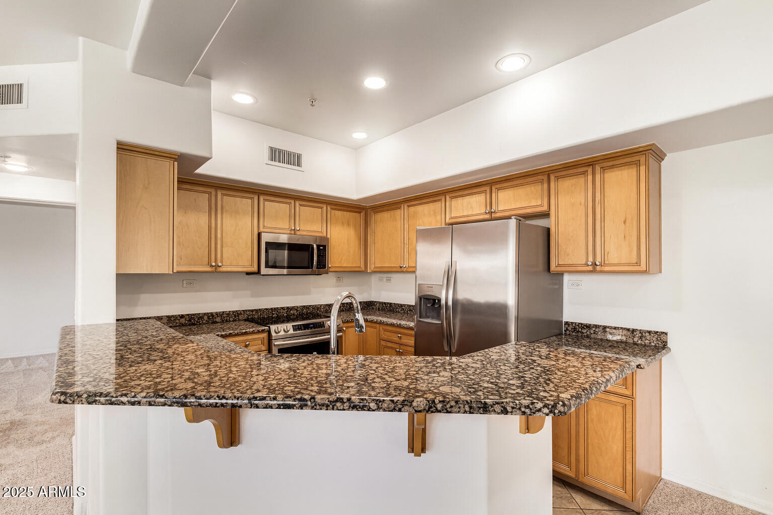 20660 North 40th Street, Unit 2120 Phoenix, AZ 85050 - Photo 6 of 39 a kitchen with stainless steel appliances granite countertop a sink stove and refrigerator