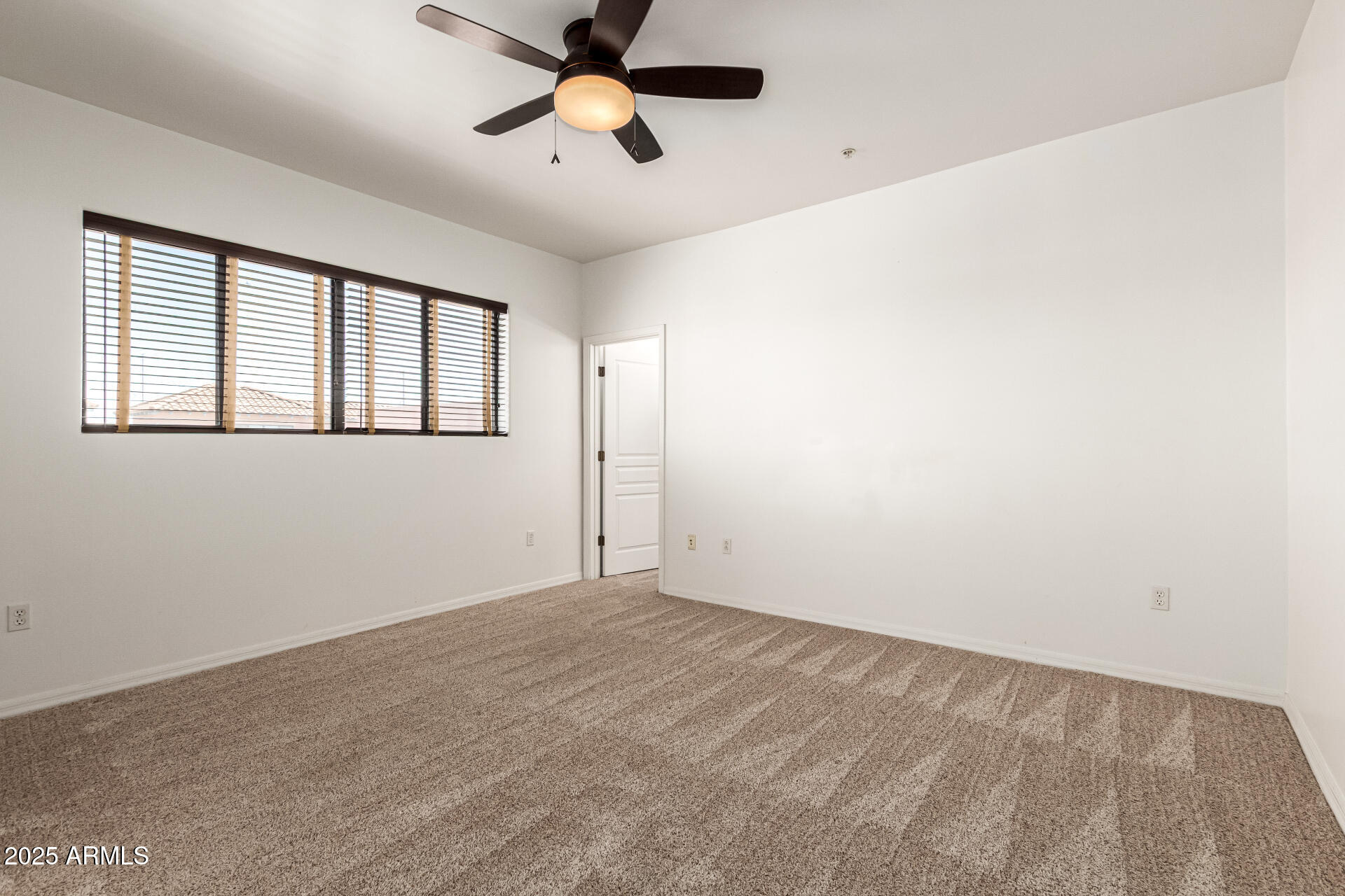 20660 North 40th Street, Unit 2120 Phoenix, AZ 85050 - Photo 9 of 39 an empty room with windows and fan