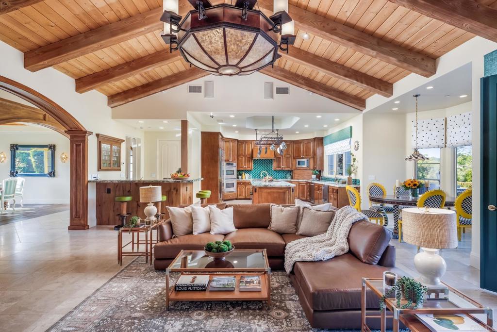 4843 La Jacaranda Rancho Santa Fe, CA 92067 - Photo 11 of 61 a living room with furniture a ceiling fan and a rug