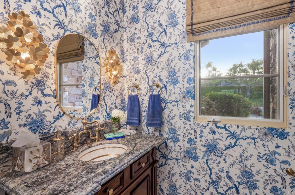 4843 La Jacaranda Rancho Santa Fe, CA 92067 - Photo 21 of 61 a bathroom with a granite countertop sink and a mirror