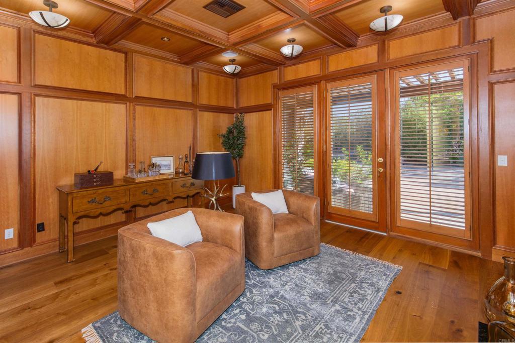 4843 La Jacaranda Rancho Santa Fe, CA 92067 - Photo 28 of 61 a living room with furniture a rug and a floor to ceiling window