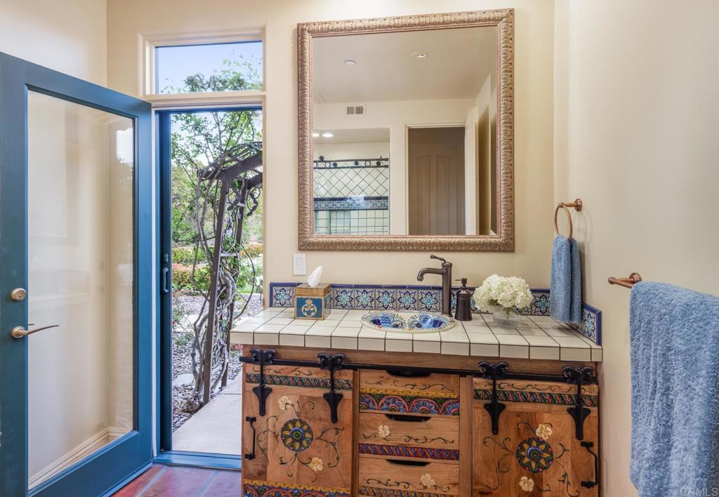 4843 La Jacaranda Rancho Santa Fe, CA 92067 - Photo 36 of 61 a bathroom with a sink and a mirror