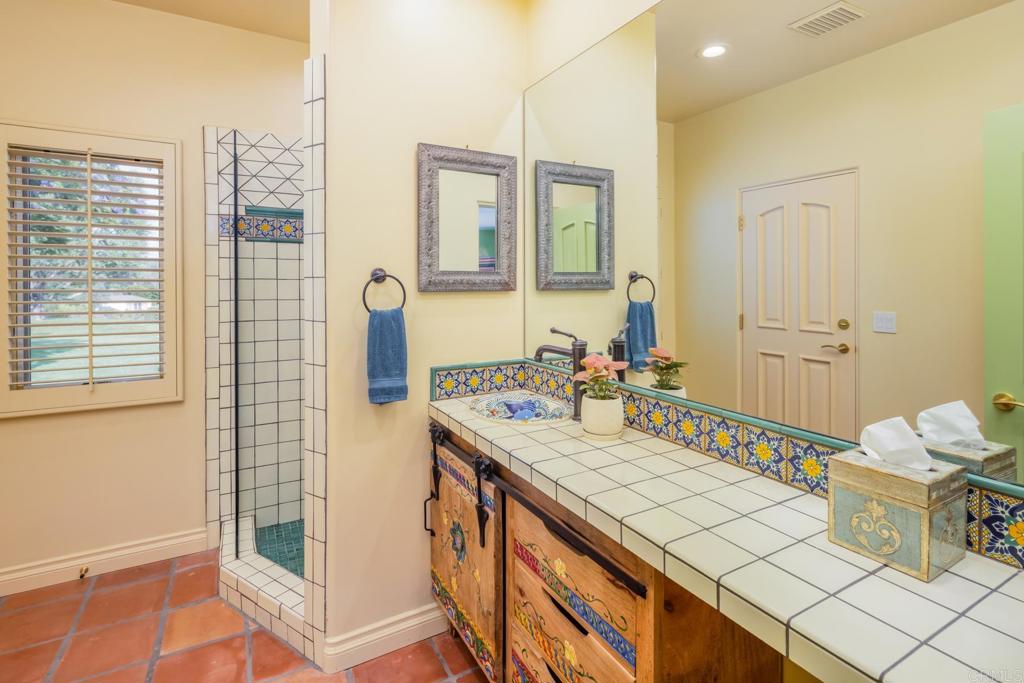 4843 La Jacaranda Rancho Santa Fe, CA 92067 - Photo 53 of 61 a bathroom with a sink mirror and vanity
