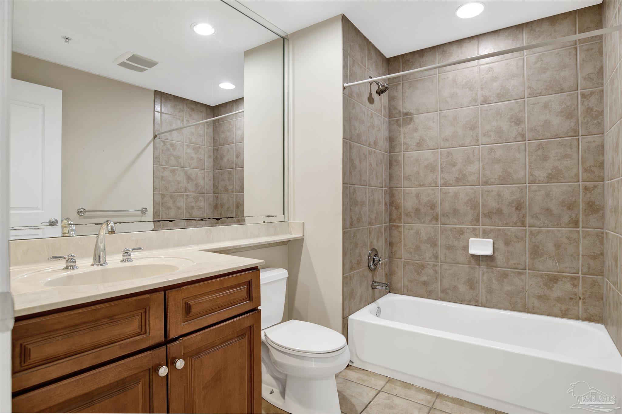 612 Lost Key Drive, Unit 401B Pensacola, FL 32507 - Photo 12 of 34 a bathroom with a sink a toilet and a bathtub