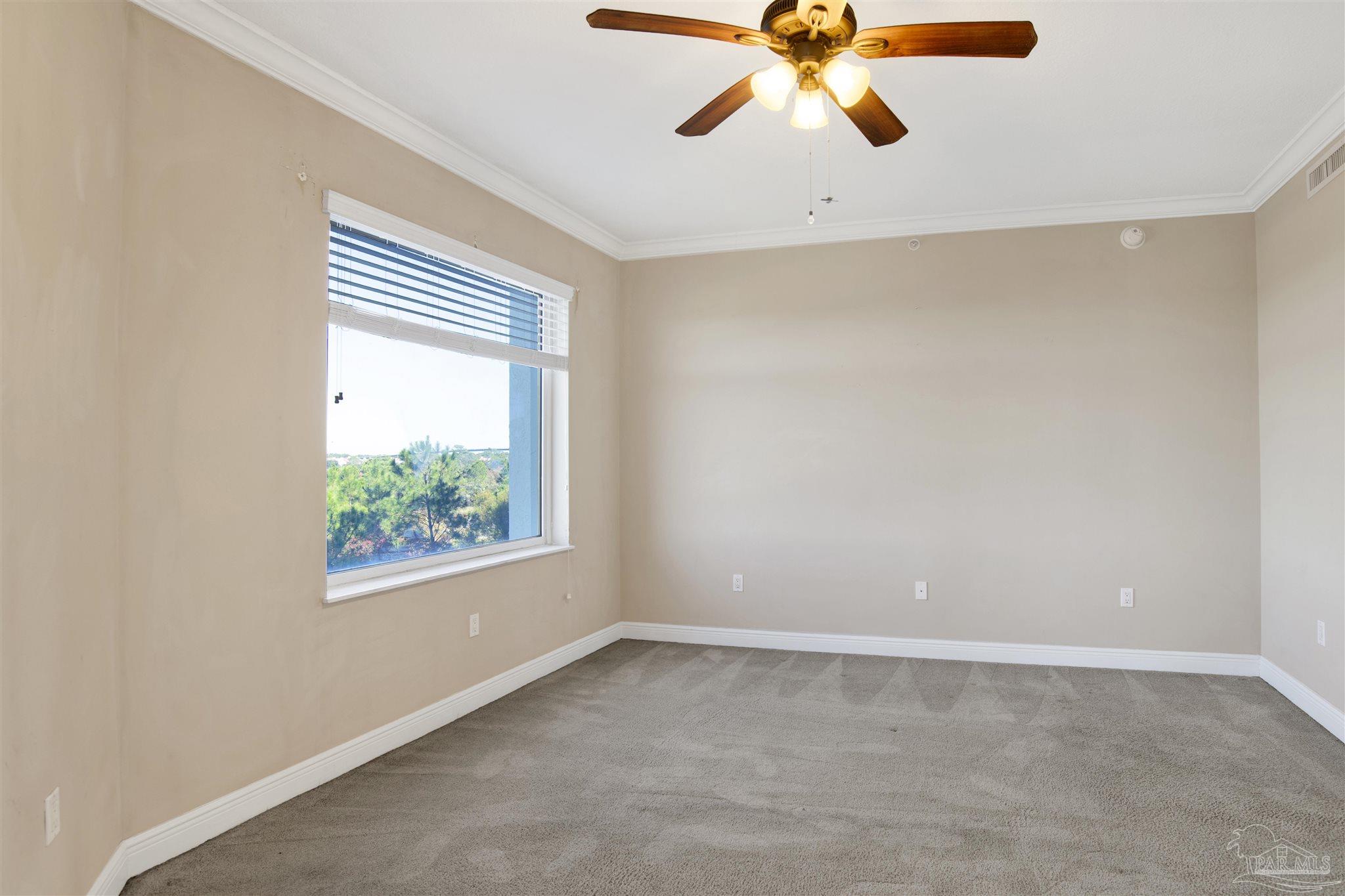 612 Lost Key Drive, Unit 401B Pensacola, FL 32507 - Photo 25 of 34 an empty room with windows and fan