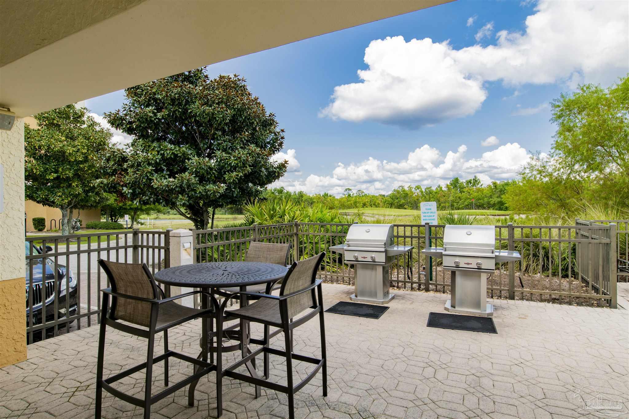 612 Lost Key Drive, Unit 401B Pensacola, FL 32507 - Photo 29 of 34 a view of a chairs and table in the patio