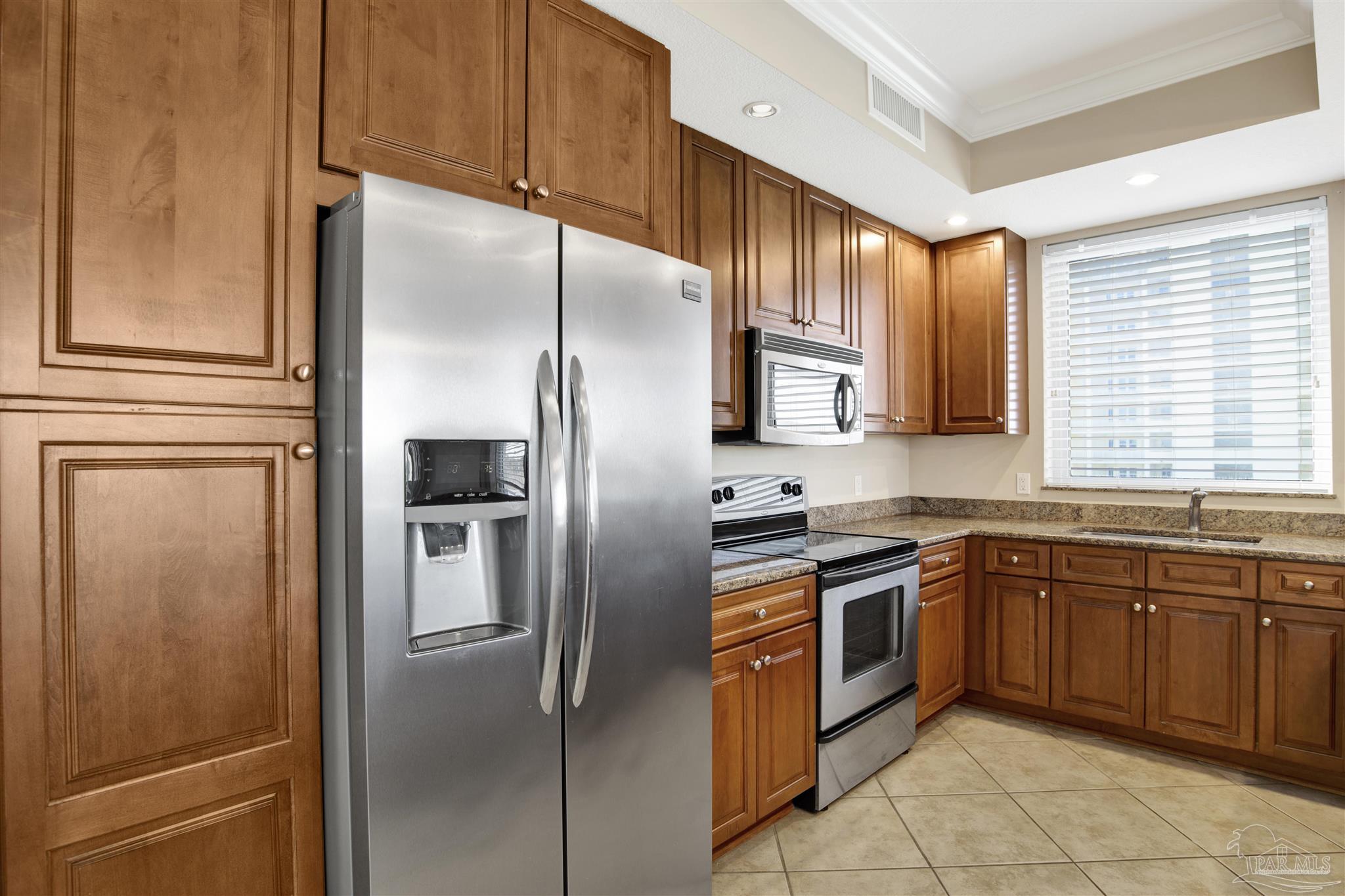 612 Lost Key Drive, Unit 401B Pensacola, FL 32507 - Photo 3 of 34 a kitchen with stainless steel appliances granite countertop a refrigerator and a sink