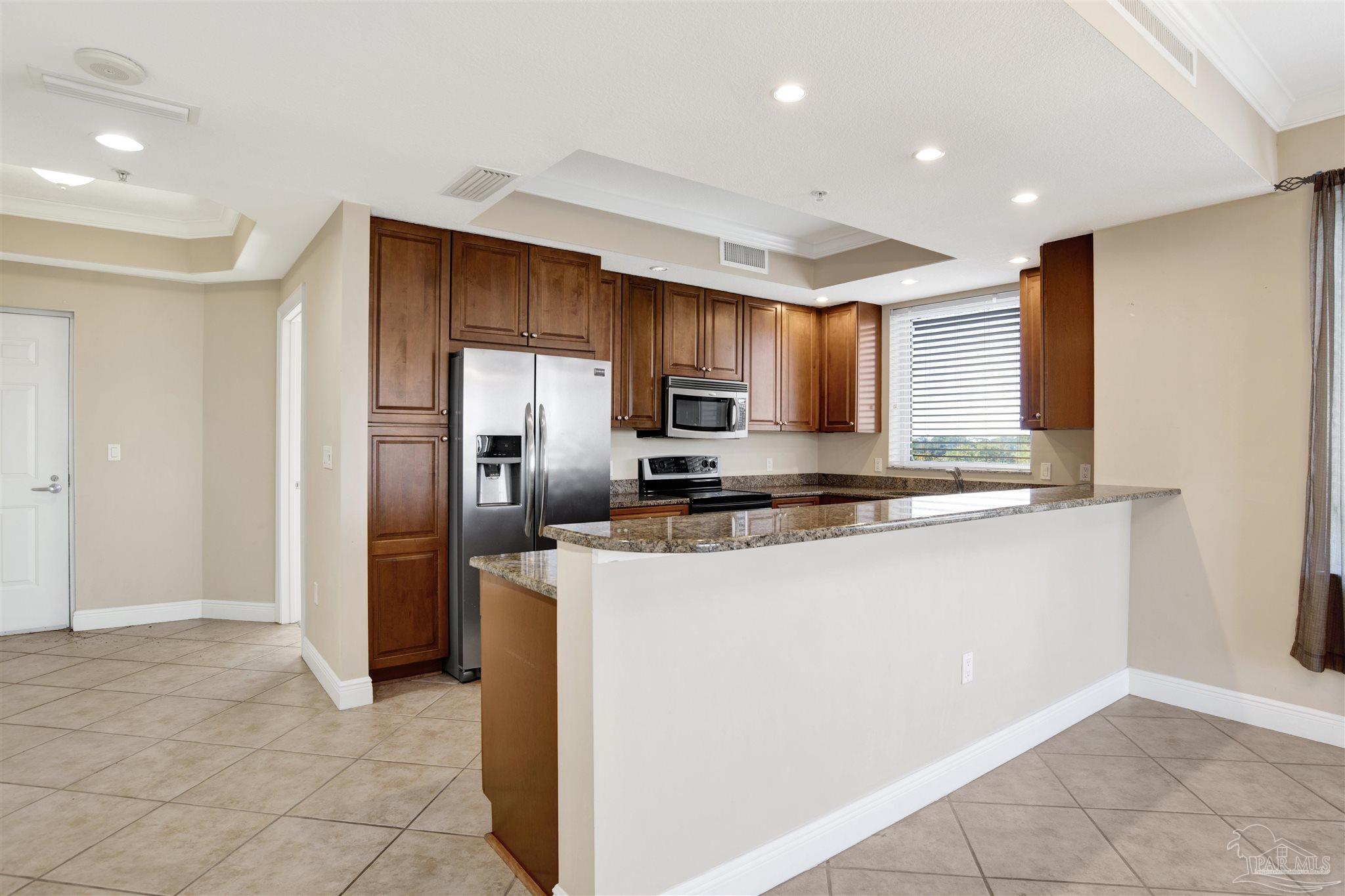 612 Lost Key Drive, Unit 401B Pensacola, FL 32507 - Photo 4 of 34 a kitchen with stainless steel appliances granite countertop a refrigerator and a stove