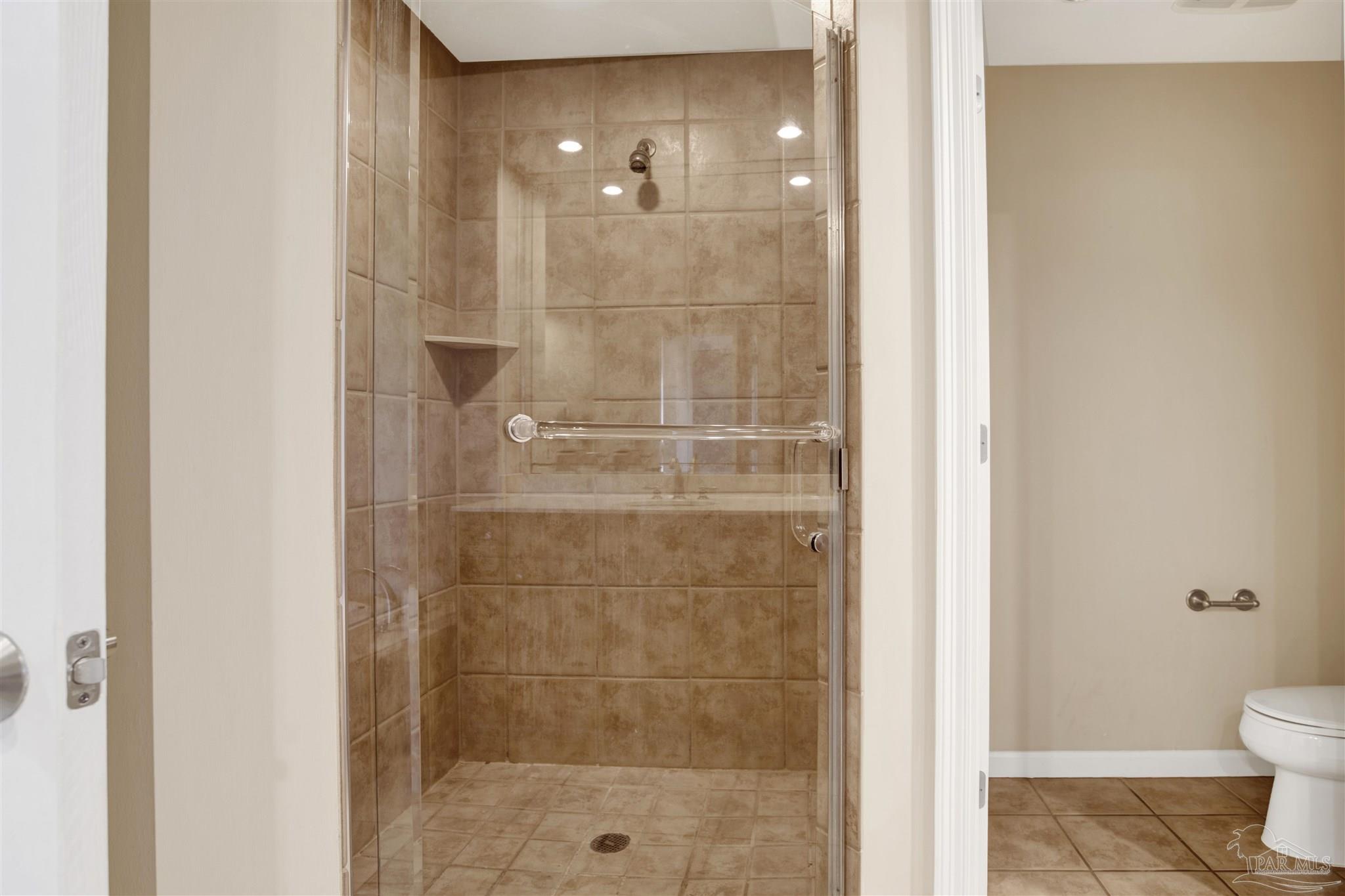 612 Lost Key Drive, Unit 401B Pensacola, FL 32507 - Photo 9 of 34 a bathroom with a shower and a toilet