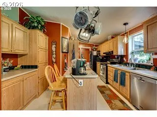 a kitchen with stainless steel appliances kitchen island granite countertop a stove and cabinets