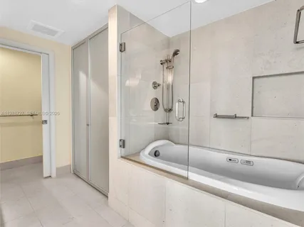 a bathroom with a shower and a bathtub