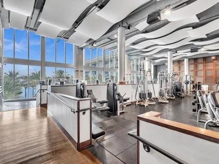 a living room with lots of furniture and a large window