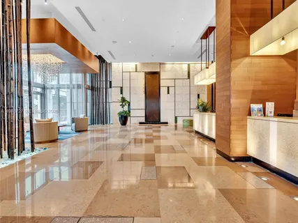 a view of a lobby with furniture and floor to ceiling windows