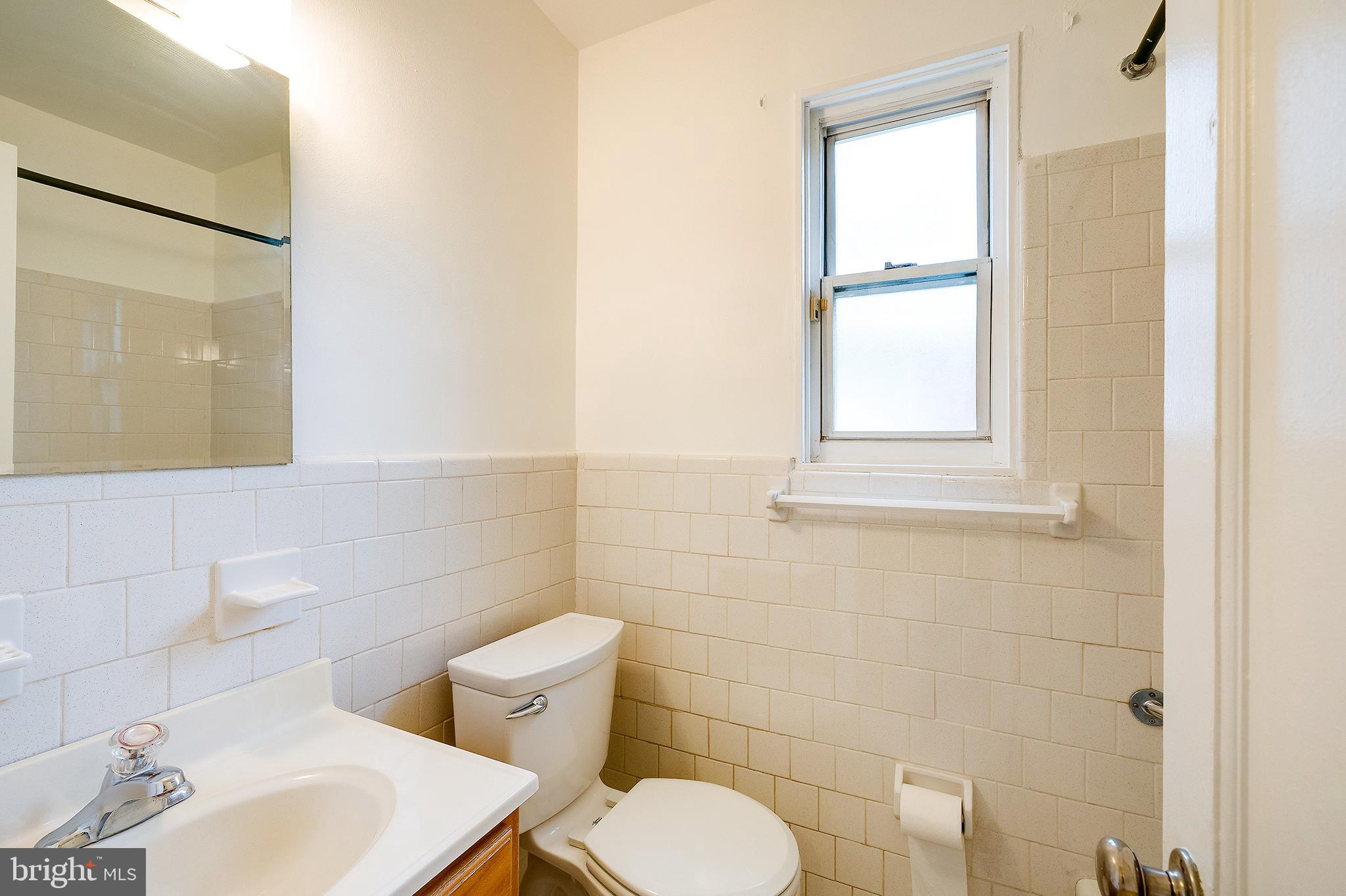 6159 1st Street Northeast Washington, DC 20011 - Photo 17 of 28 a bathroom with a toilet sink and mirror