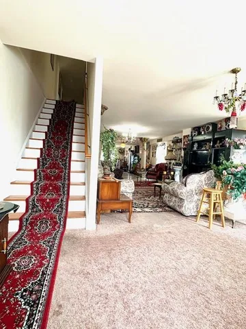 a view of living room with furniture and a rug
