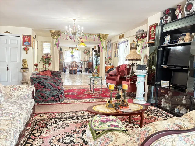 a living room with furniture and a chandelier