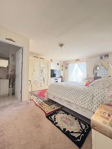 a bedroom with a bed and a dresser