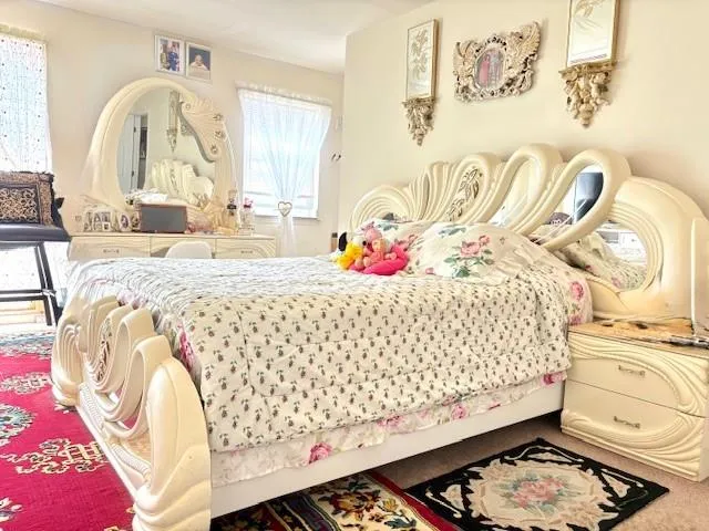 a bedroom with a bed and dresser