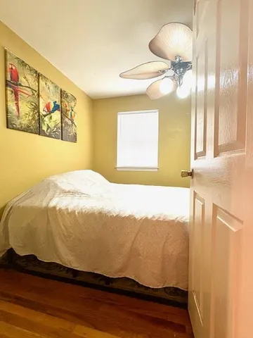 a bedroom with a bed and a painting on the wall