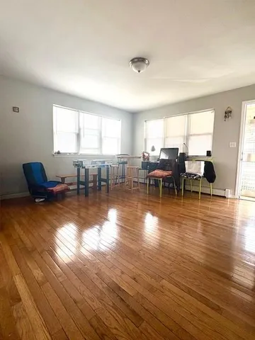 a living room with furniture window and wooden floor
