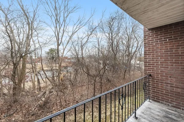 a view of balcony with wooden fence