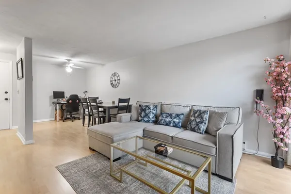 a living room with furniture and wooden floor