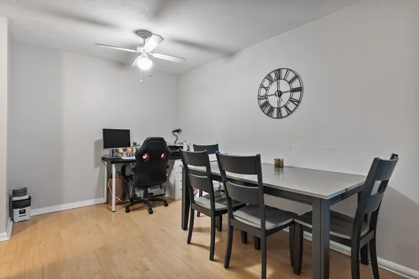 a view of a dining room with furniture and a chandelier fan