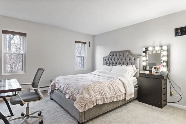 a bedroom with a bed a table and chair