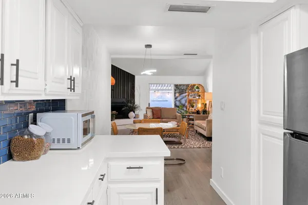 a kitchen with cabinets appliances and a counter space
