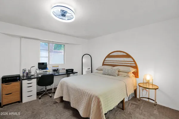 a living room with furniture a flat screen tv and a window