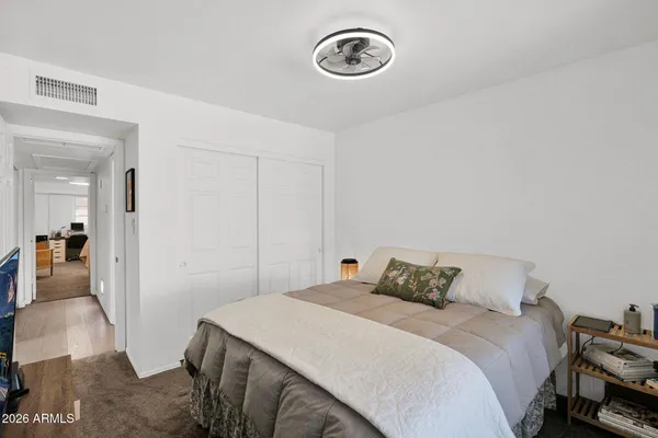 a bedroom with a bed and a table