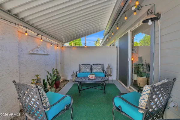 a view of a roof deck with table and chairs a barbeque with wooden floor and fence